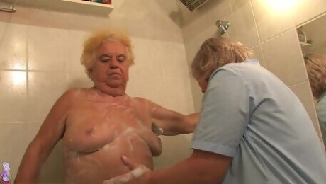 A younger guy showers, toys then fucks a very old granny