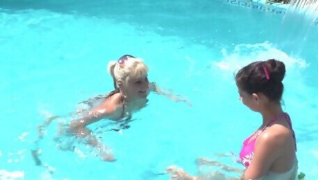 Mature blonde eating out the pussy of her younger friend at the pool