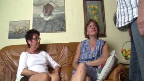 Mature German babes share a stiff fuckrod on the couch