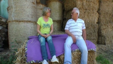 Mature lusty grey haired village slut wanks and sucks dick on straw in shed
