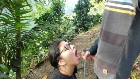 Latina with glasses and big tits gives a blowjob outdoors